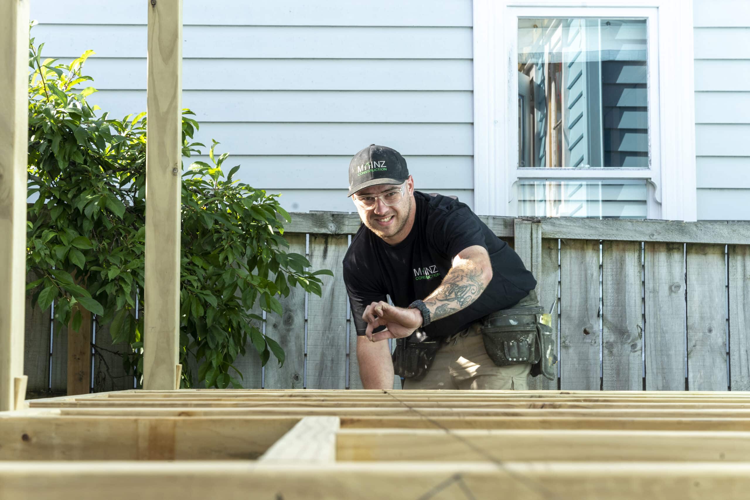 The founder of Mainz Construction making use of a chalk line while building.