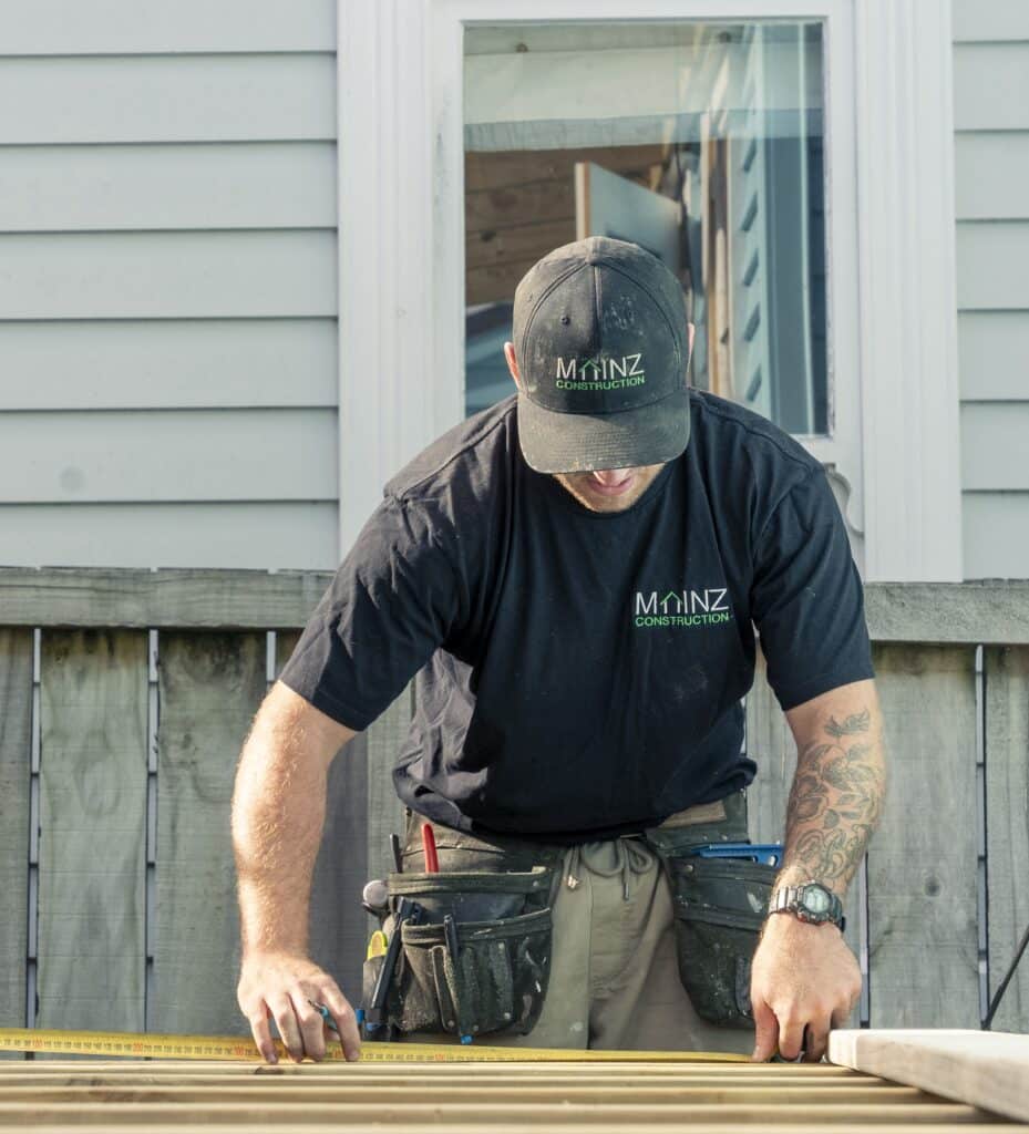 The founder of Mainz Construction measuring on a building site.